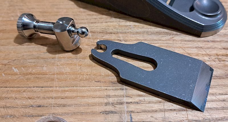 Blade adjuster and blade